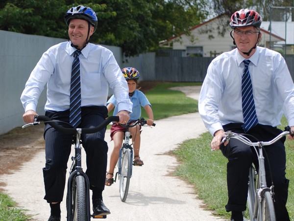 Prime Minister John Key rides a bike